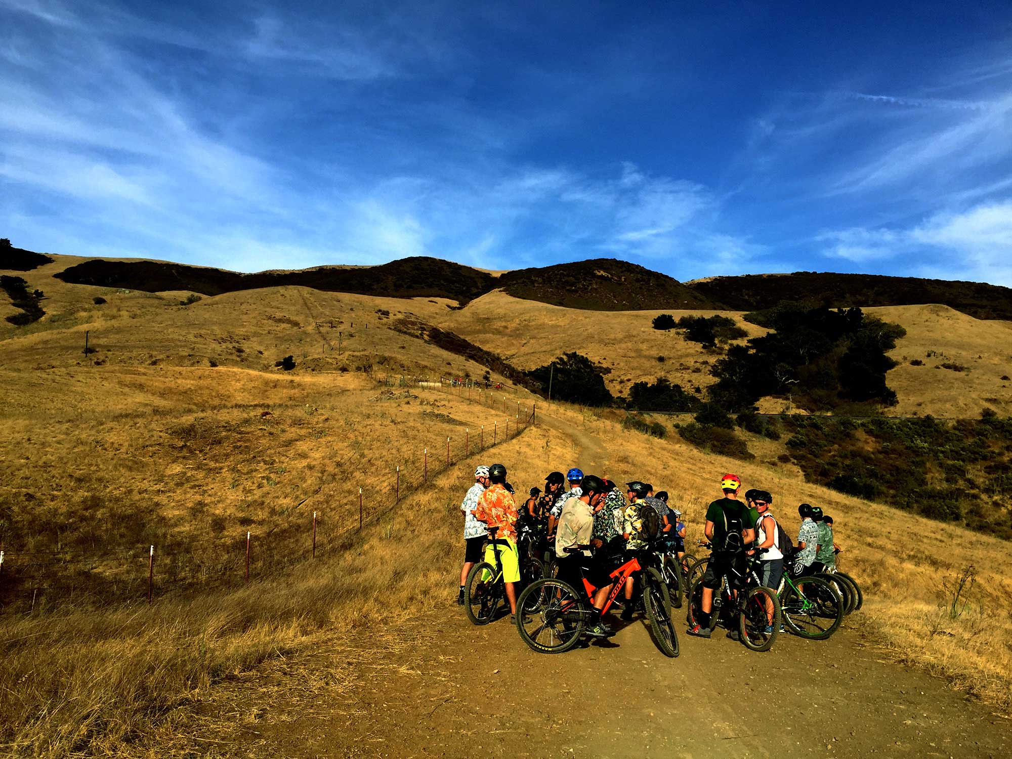 Oct. 7, 2016 – Before colliding with an active set of railroad tracks on West Cuesta Ridge, Cal Poly Cycling mountain bikers regroup with their compatriots. On this particular day, 38 team members joined the movement, all clad in Hawaiian shirts.