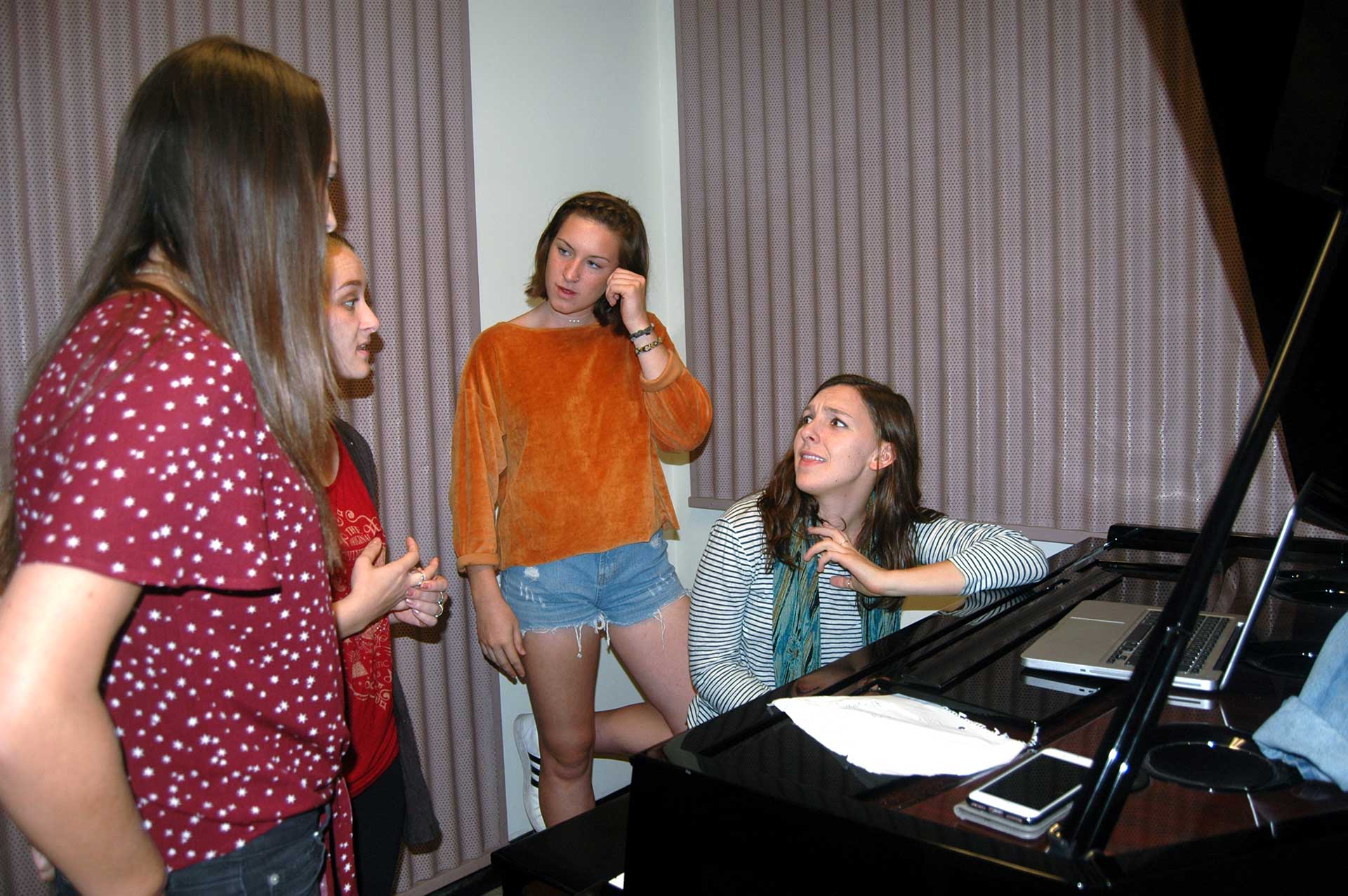 October 8, 2017 | San Luis Obispo, CA | Meanwhile, the altos retreat to a smaller practice room
for their sectional. Nutrition senior Jennifer Gsell (right) debates with fellow alto singer,
architecture senior Paris Allen (second from left.) The ladies can’t decide on whether a
particular note they sing should “fit the chord” or be dissonant. Gsell claims, “I don’t think that’s
how it’s all supposed to fit together. It doesn’t sound quite right.” They continue to practice the
same vocal line substituting either note.