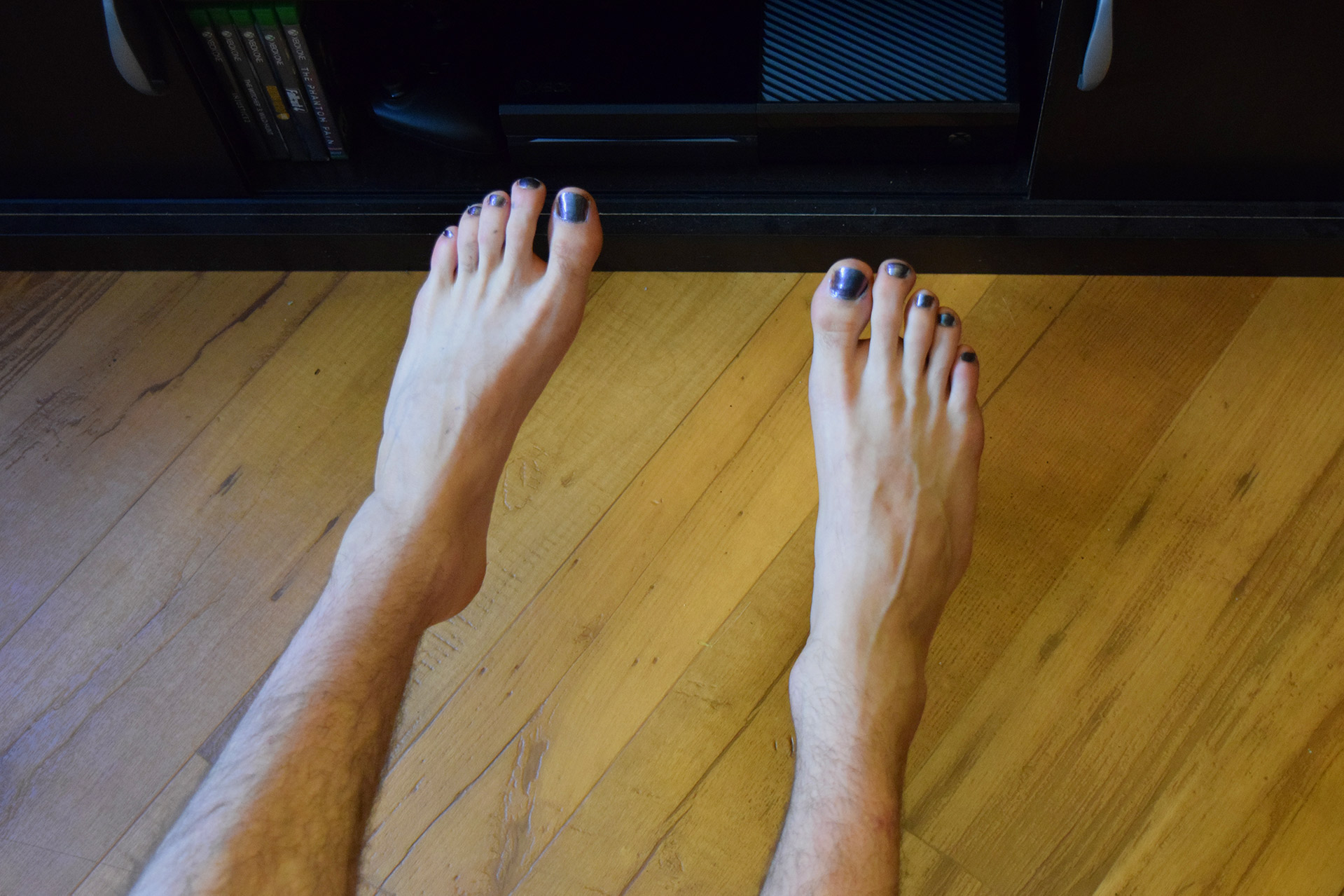  Cole flaunts his fabulous toenails, which flash green and purple in the light. Photo Credit: Katelyn Biddle