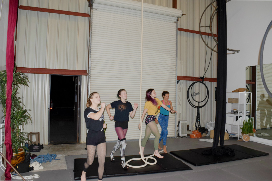 As the music starts, Cheyenne Miller, Julia Nowak, Nikki Pesce and Jamie Relth dance to their silks to practice their “Clowns” routine. They ran through the piece three or four times throughout the night, while Penton gave shouts of encouragement over the circus-themed song.
