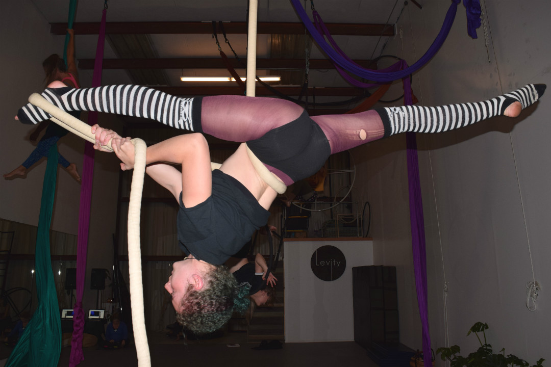 Julia Nowak, suspended from a rope, does a full midair split. Nowak, like all of the other aerialists, completed a full stretching routine prior to attempting any aerial moves in order to fully warm up and prevent injury.