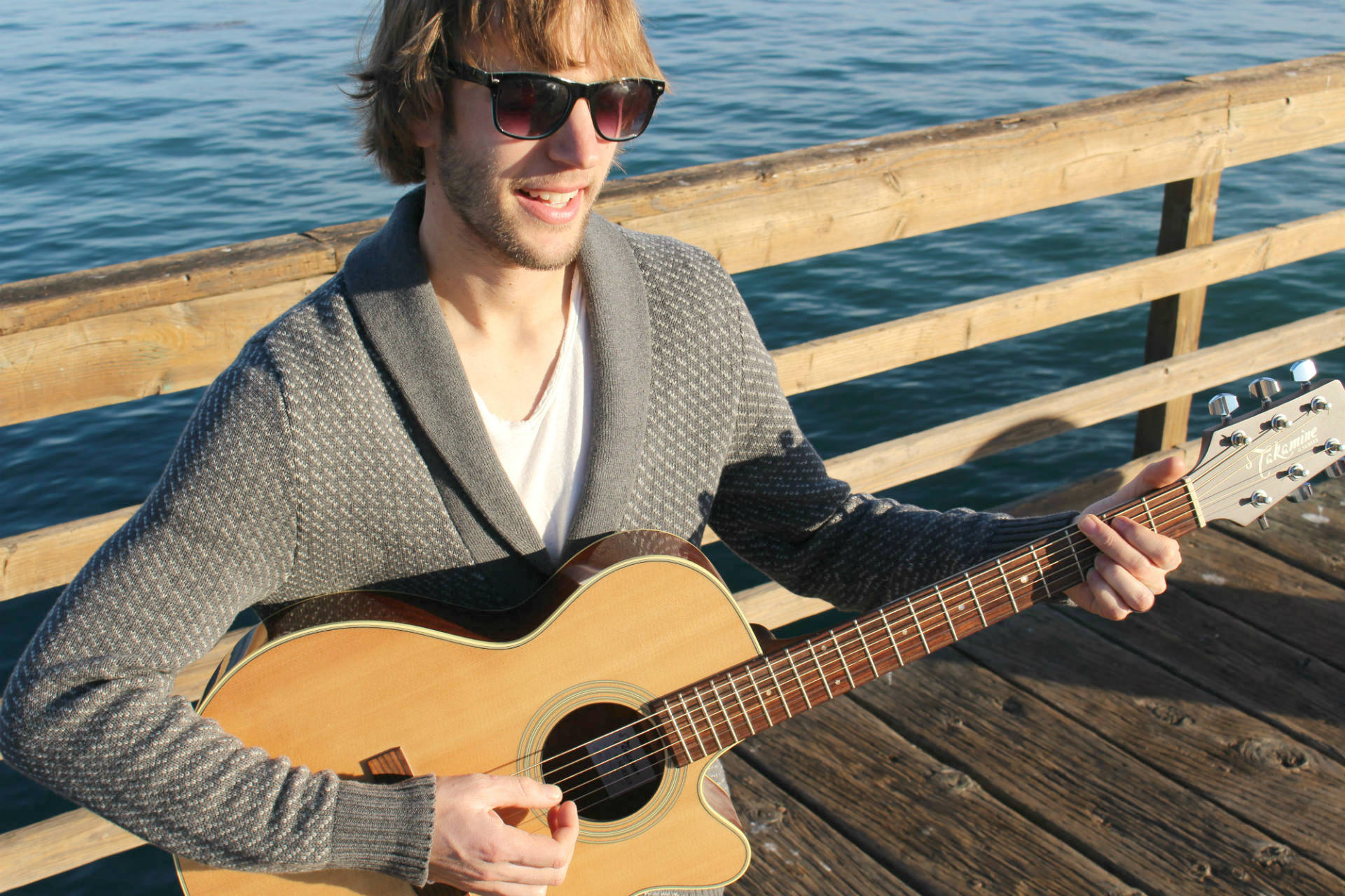<b>The songwriter himself.</b>
Justin Hooper fingerpicks a song from the new album 'A Love Story' on the guitar in Avila Beach, California. 'I have been writing songs since I was 19, which was before I met Kayla. Over the years, they turned out to evolve into what love really looks like—not just the romance of it, but how much worth it everything is than I thought it would be. She is the muse.'
