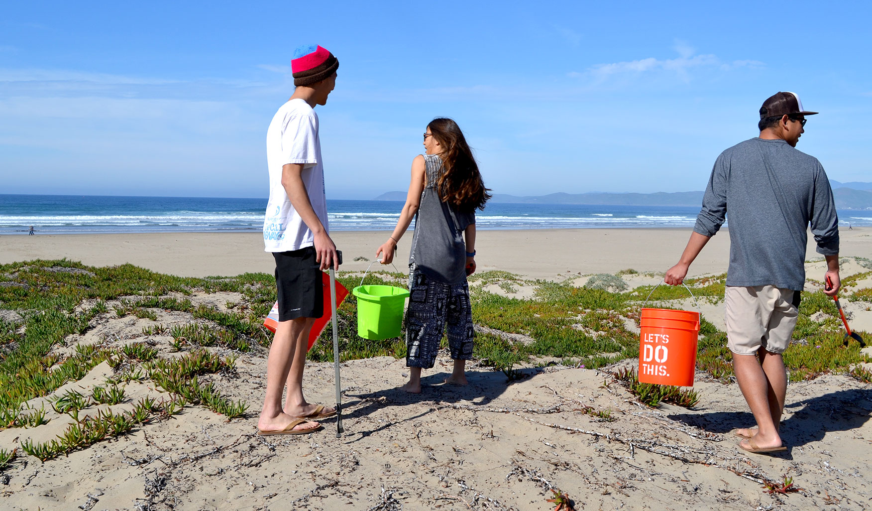 5th year Industrial Engineering major and Club President Alex Ly, Camille Morr, and English major graduate Liam Hedriana scour the sand for debris left behind by beach-goers. 'We actually struggled to find trash today,' said Hedriana.
'But I think that’s good, because we’re used to cleaning up places like Pirate’s Cove and finding 300 pounds of trash. People are sleeping on the beach there, we find condoms on condoms.'