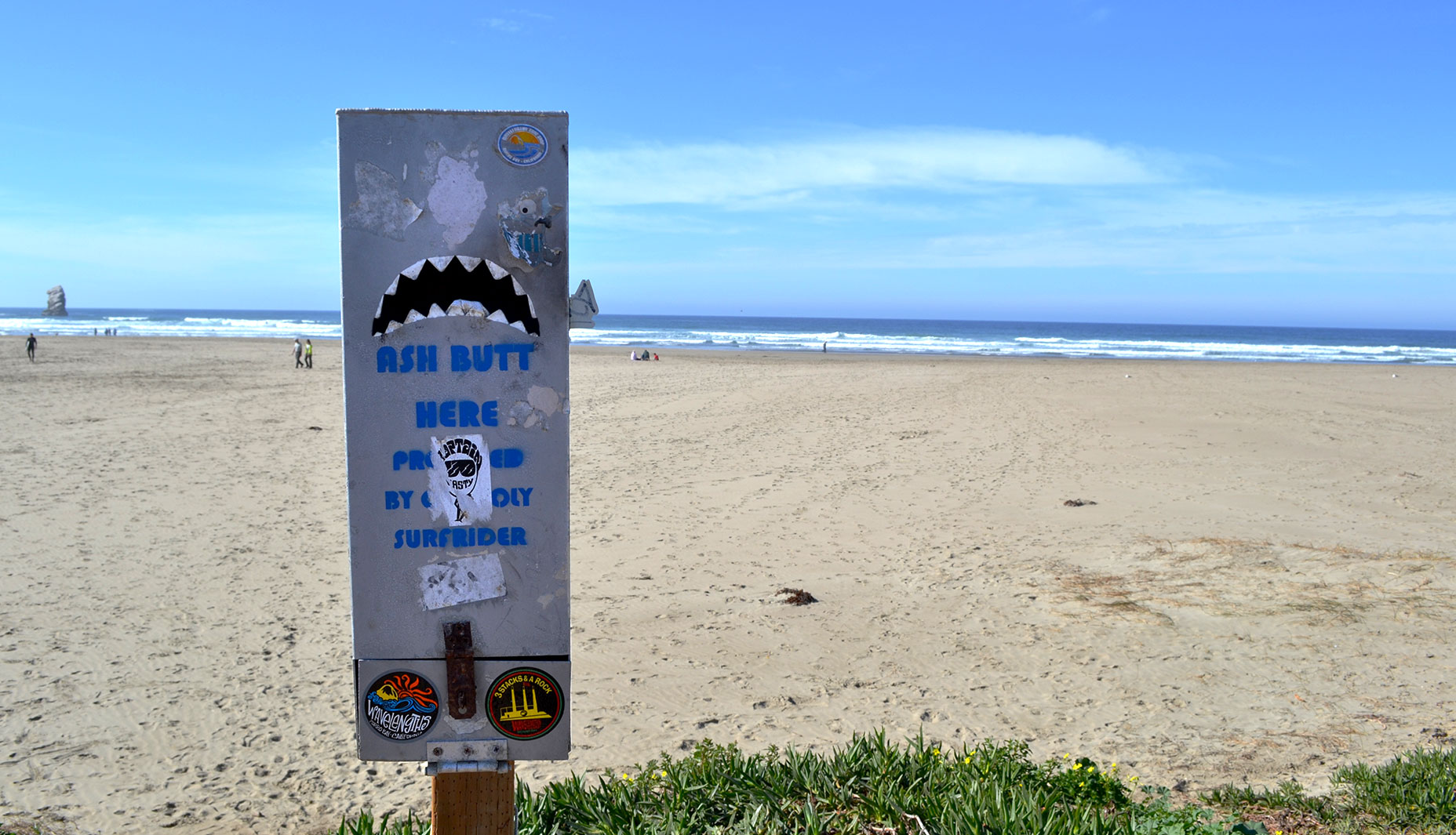 A trash receptacle made to look like the mouth of a shark stands at the edge of the parking lot. The words partly covered by stickers read, 'PROVIDED BY CAL POLY SURFRIDER'. The club makes efforts to make beach cleaning as easy as possible for others who visit. The club’s next project: working with the city of Morro Bay and Morro Bay High School Surf Club to install trash cans in the parking lot of The Pit. 