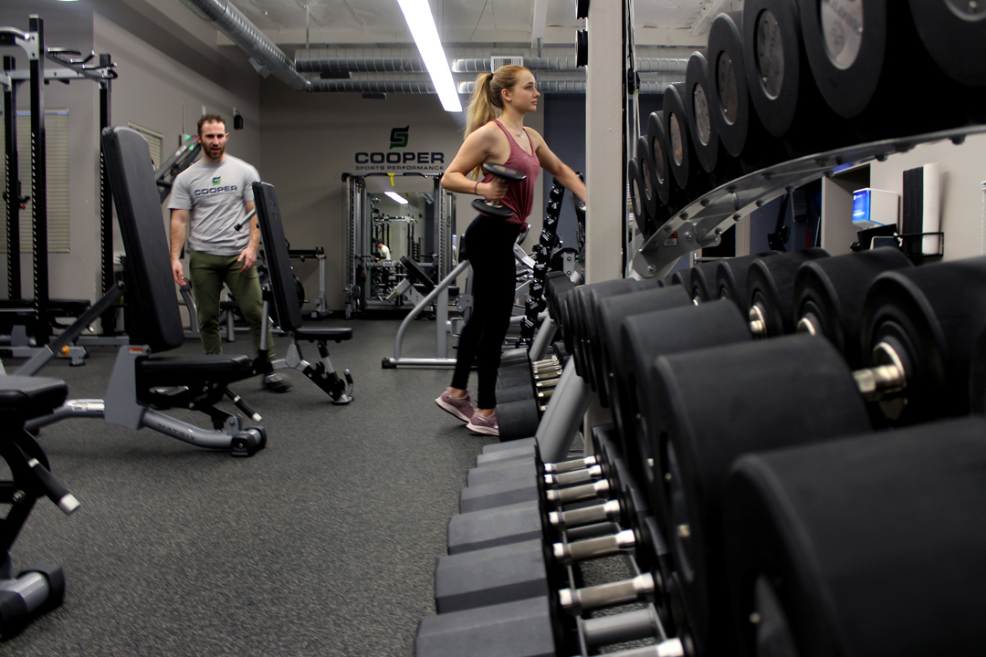 Campbell moves on to an upper-body strength exercise. Her journey with weight lifting began because her friends peer-pressured her into attending the gym with them. Three years later and she has decided to pursue the path of personal training herself. Photo Credit: Taylor Keefer